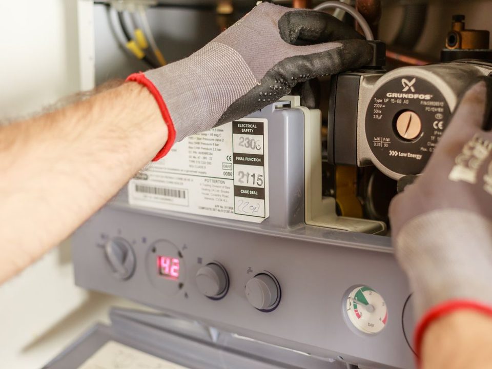 Technician working on a boiler circulator pump